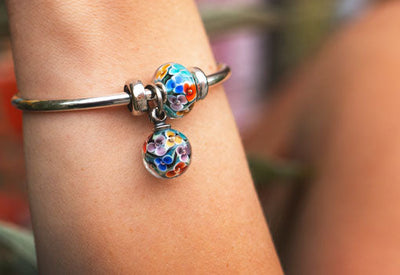 Colourful Daydream Blossom tassel and bead in blue glass with rainbow flowers
